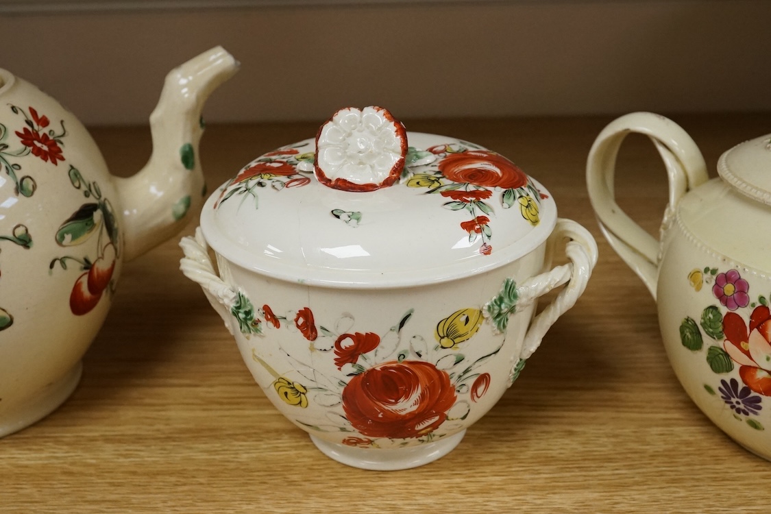 Two George III creamware teapots and a lidded sugar bowl, c.1780, largest 20cm wide